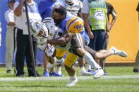 Pittsburgh defensive lineman Habakkuk Baldonado, right, loses his helmet as he tackles Western Michigan wide receiver Skyy Moore (24) during the first half of an NCAA college football game, Saturday, Sept. 18, 2021, in Pittsburgh. (AP Photo/Keith Srakocic)