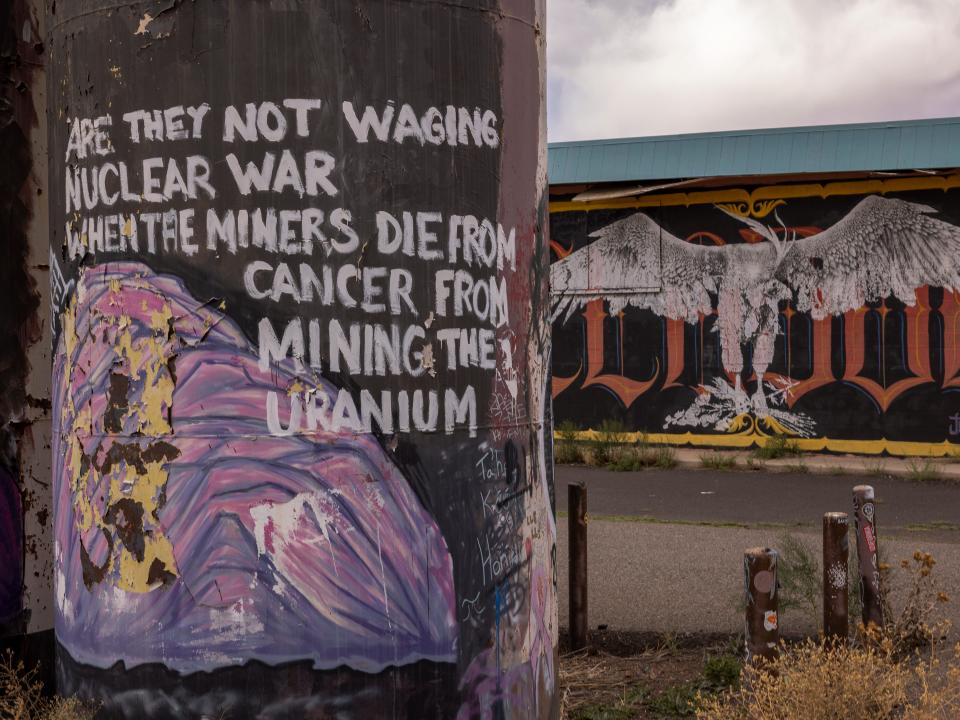 A message about uranium mine cancer deaths is seen painted on an abandoned tank on the Navajo Nation near Cameron, Arizona.