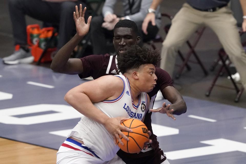 Louisiana Tech forward Kenneth Lofton Jr. (2) works against Mississippi State forward Abdul Ado, rear, for a shot opportunity in the first half of an NCAA college basketball game in the semifinals of the NIT, Saturday, March 27, 2021, in Frisco, Texas. (AP Photo/Tony Gutierrez)