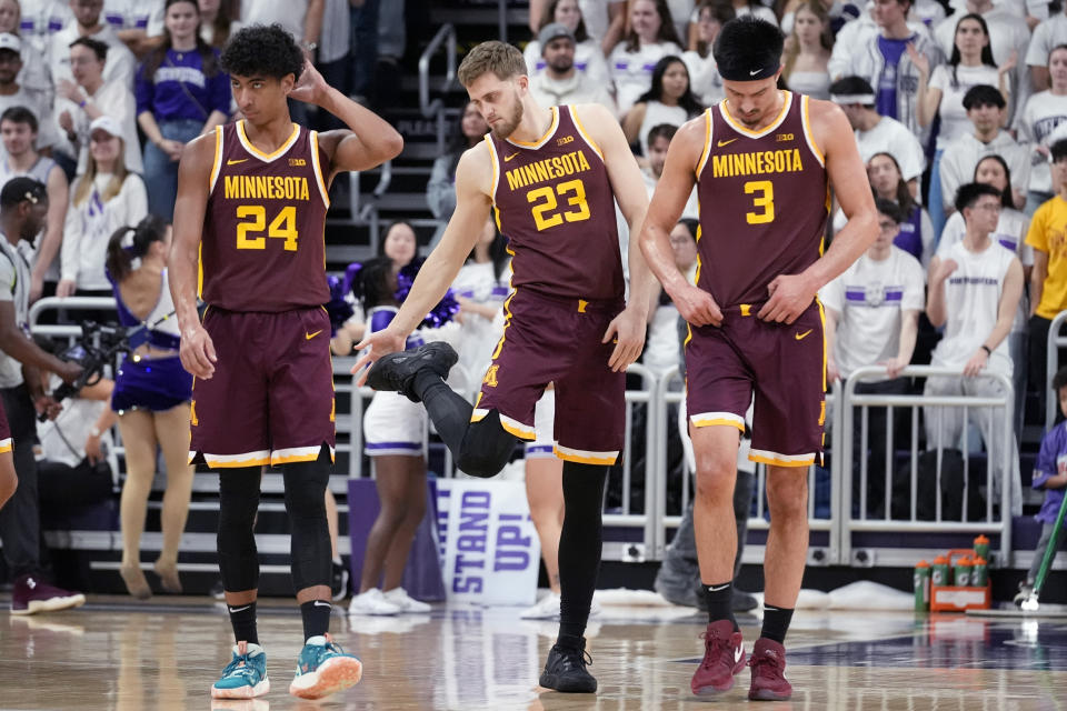 Minnesota guard Cam Christie, left, forward Parker Fox, center, and forward Dawson Garcia, right, walk on the court during the first half of an NCAA college basketball game against Northwestern in Evanston, Ill., Saturday, March 9, 2024. (AP Photo/Nam Y. Huh)