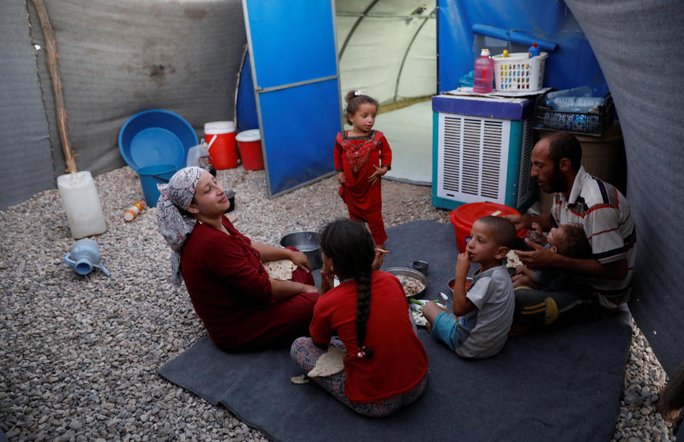 Displaced Iraqi family from Mosul eat a simple meal for their Iftar, during the Muslim holy month of Ramadan at a refugee camp al-Khazir in the outskirts of Erbil, Iraq June 10,&nbsp;