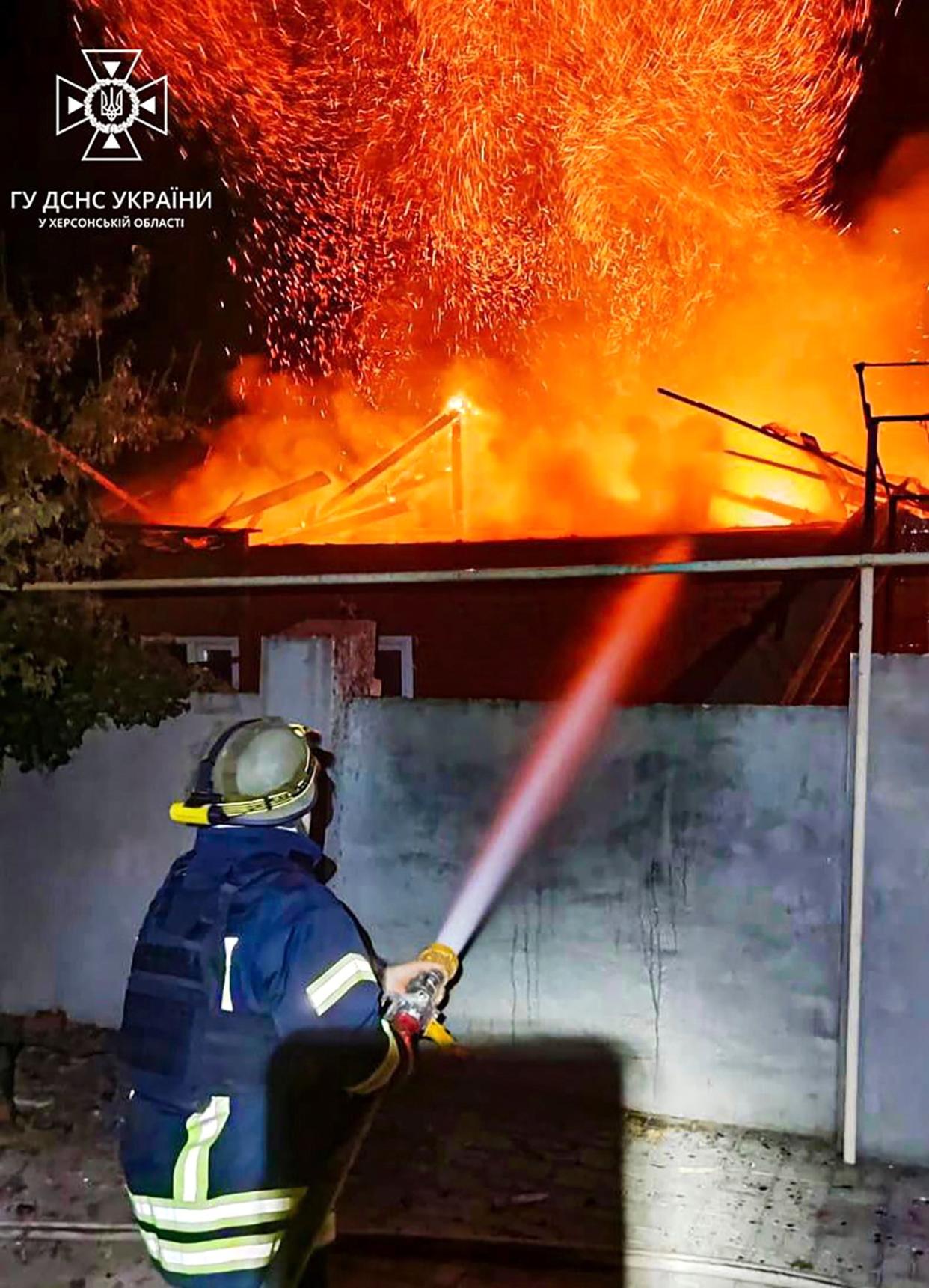 Emergency services personnel work to extinguish a fire in Kherson, Ukraine (AP/ Ukrainian Emergency Service)