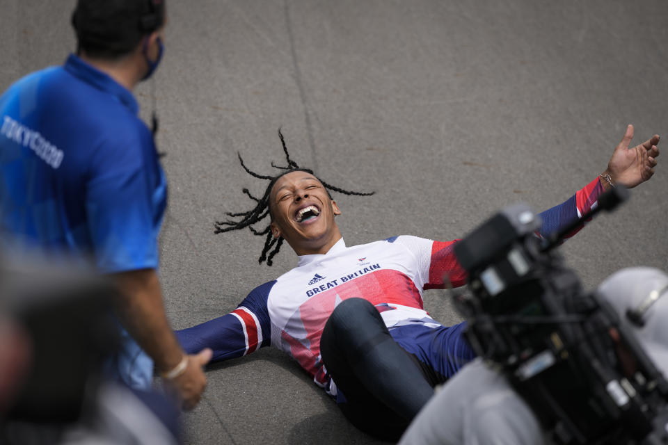 Kye Whyte of Britain lays on the track after winning the silver medal in the men's BMX Racing finals at the 2020 Summer Olympics, Friday, July 30, 2021, in Tokyo, Japan. (AP Photo/Ben Curtis)