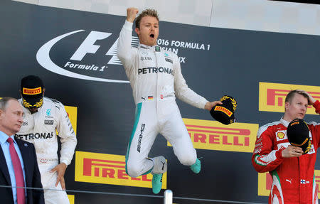 Mercedes F1 driver Nico Rosberg of Germany (C) jumps on the podium as he celebrates victory during the Russian Grand Prix. REUTERS/Maxim Shemetov