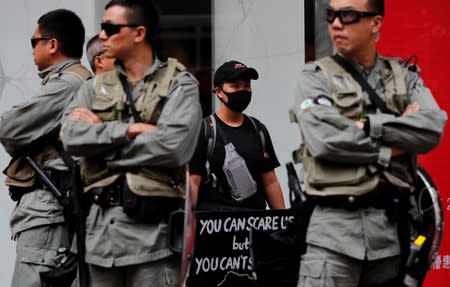 Anti-government protester holds a placard during a demonstration at Causeway Bay shopping district in Hong Kong