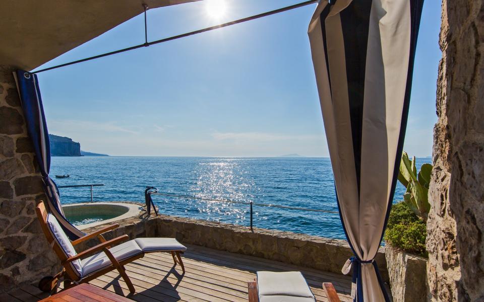 Terrace with loungers and hot tub overlooking the ocean