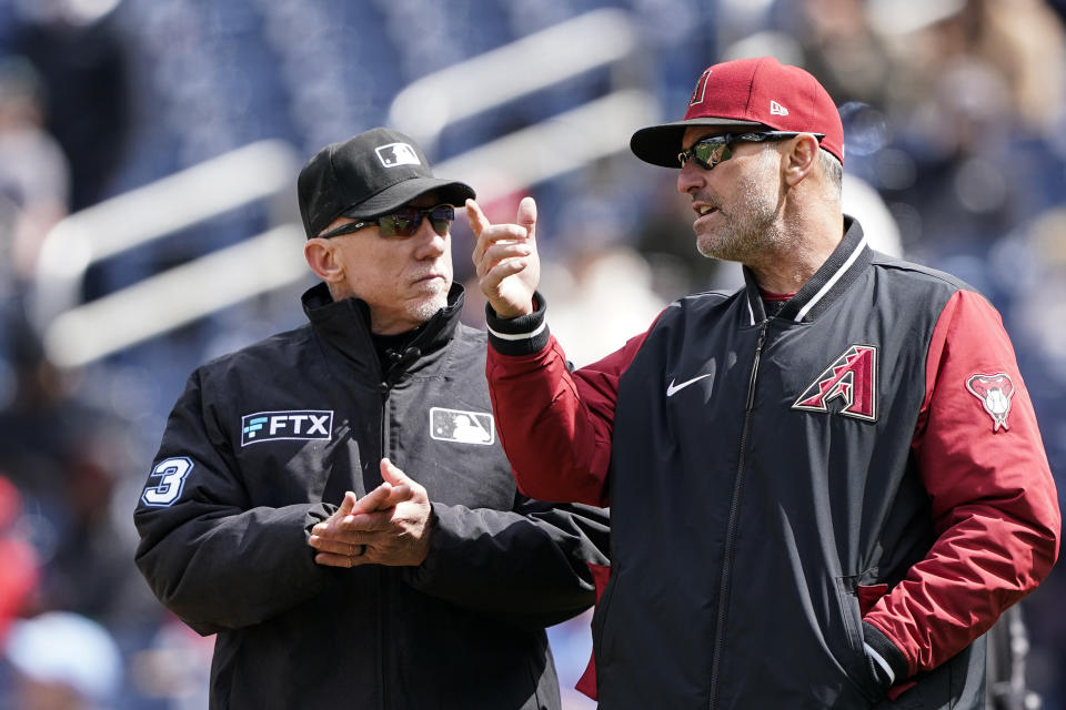 FILE - Umpire Lance Barksdale, left, talks with Arizona Diamondbacks manager Torey Lovullo during the fifth inning in the first game of a baseball doubleheader against the Washington Nationals at Nationals Park, Tuesday, April 19, 2022, in Washington. America is facing a real crisis in prep and youth sports, where fewer and fewer people are willing to take on the thankless job of officiating games. (AP Photo/Alex Brandon, File)