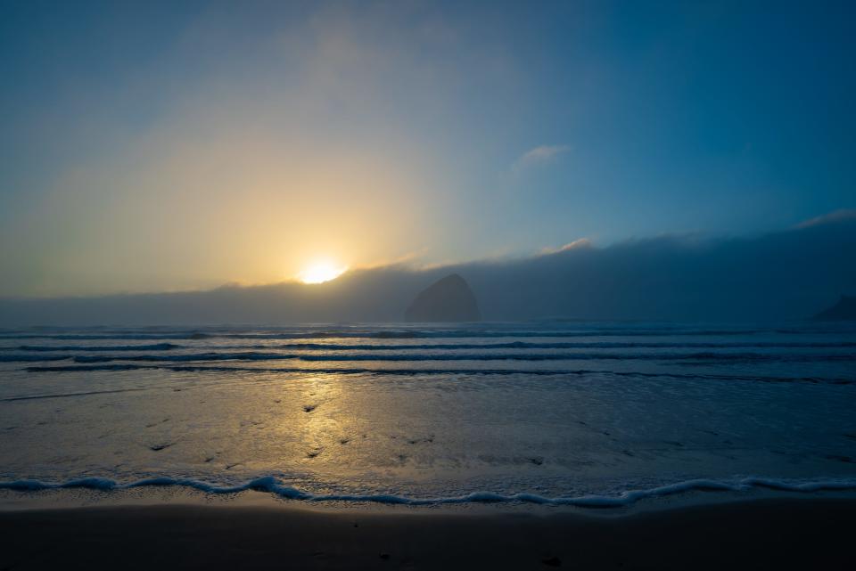 sun over a beach with blue skies