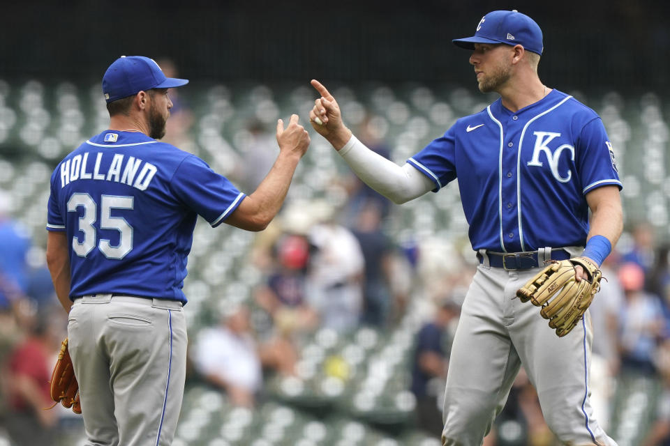 Kansas City Royals relief pitcher Greg Holland, left, celebrates with Hunter Dozier after the Royals defeated the Milwaukee Brewers 5-2 in a baseball game Tuesday, July 20, 2021, in Milwaukee. (AP Photo/Nam Y. Huh)