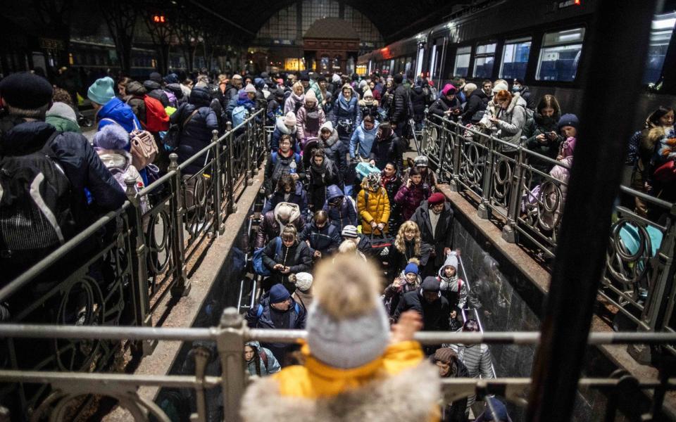 Thousands of people gather at the Lviv-Holovnyi train station in Western Ukraine in an attempt to leave the country to flee the war. - Photo by Bruno Thevenin/SIPA/Shutterstock 