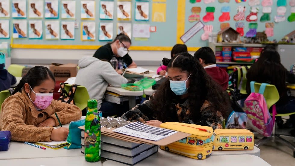 Students wears masks while working inside a 4th grade class Washington Elementary School in Lynwood, Calif.