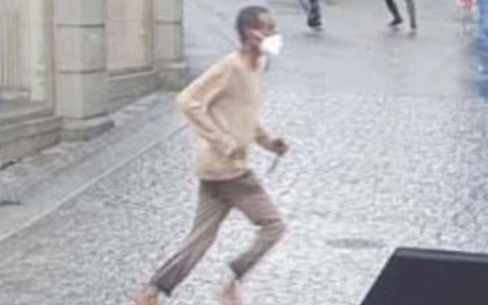 In a still from a video posted on social media, purportedly showing the attack taking place, a man is seen running across the street holding something in hid hand