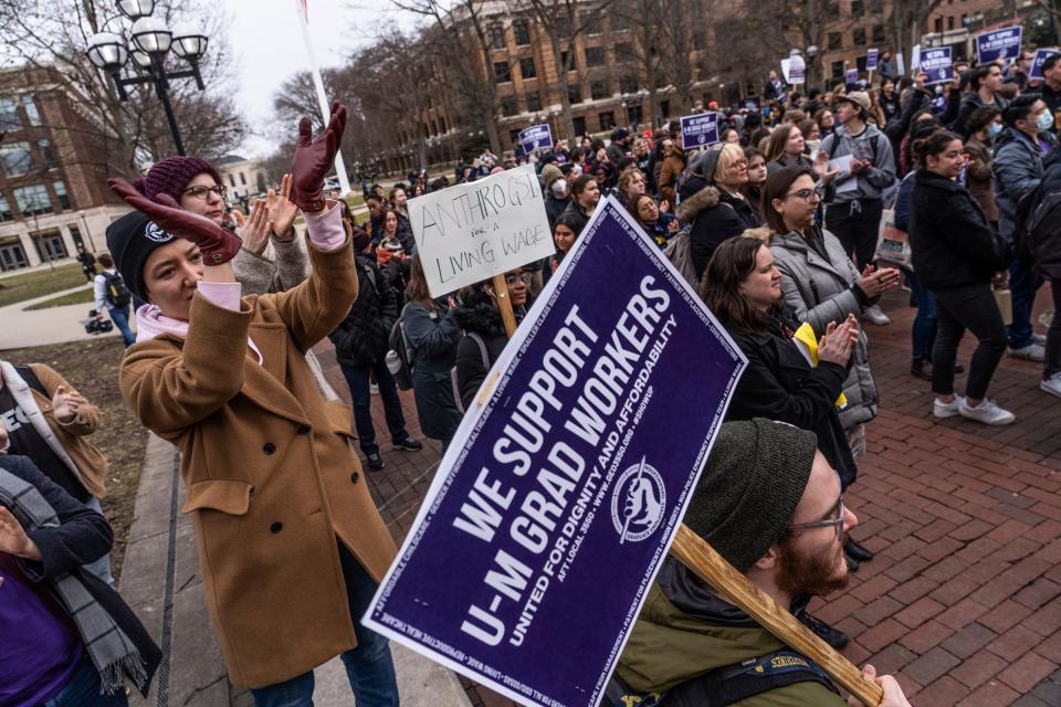 A crowd cheers on a speaker after University of Michigan graduate student workers went on strike while joined by members of the Graduate Employees Organization and allies during a rally at The Diag on the campus in Ann Arbor on March 29, 2023.