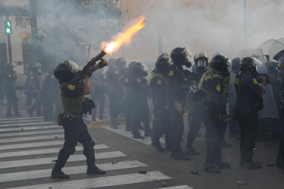 Police fire tear gas at anti-government protesters in downtown Lima, Peru, Tuesday, Jan. 24, 2023. Protesters are seeking the resignation of President Dina Boluarte, the release from prison of ousted President Pedro Castillo, immediate elections and justice for demonstrators killed in clashes with police. (AP Photo/Martin Mejia)