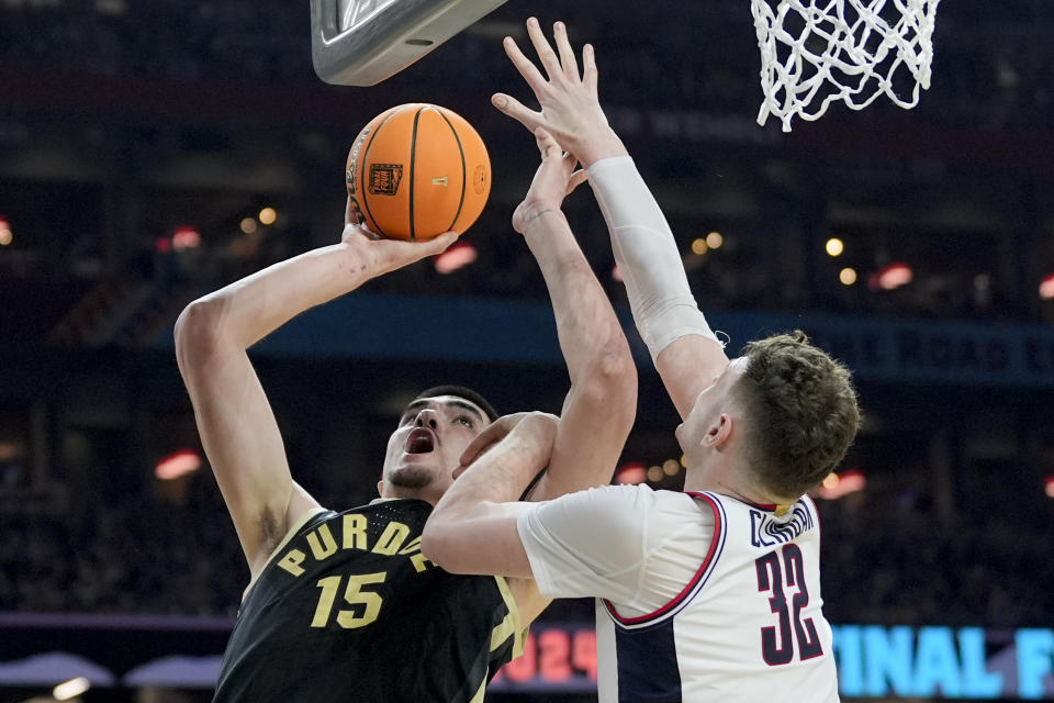 Purdue center Zach Edey (15) shoots over UConn center Donovan Clingan (32) during the first half of the NCAA college Final Four championship basketball game, Monday, April 8, 2024, in Glendale, Ariz. (AP Photo/David J. Phillip)
