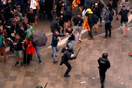 Protesters clash with police during a demonstration at Barcelona's airport, after a verdict in a trial over a banned independence referendum