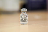 A vial of the Pfizer COVID-19 vaccine ready to be used at Swaminarayan School vaccination centre, in London, Saturday, Dec. 4, 2021. Britain says it will offer all adults a booster dose of vaccine within two months to bolster the nation's immunity as the new omicron variant of the coronavirus spreads. New measures to combat variant came into force in England on Tuesday, with face coverings again compulsory in shops and on public transport. (AP Photo/Alberto Pezzali)