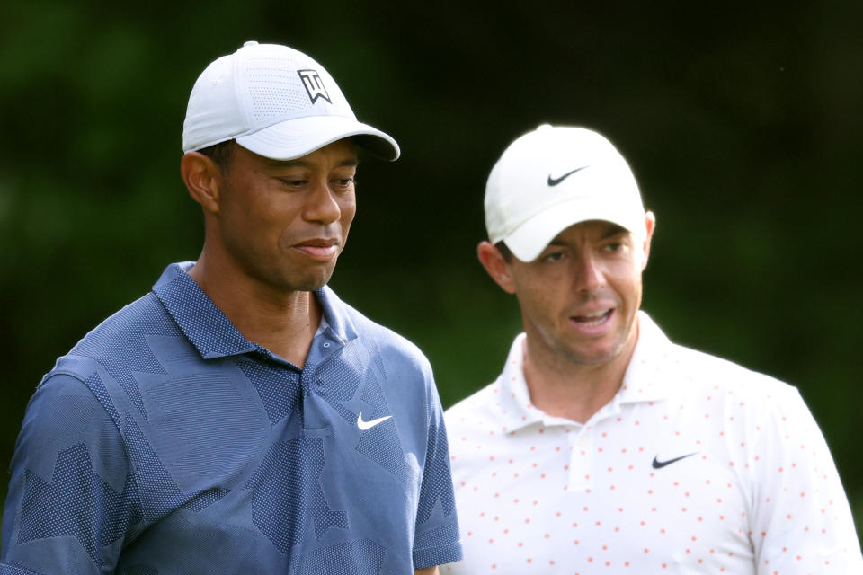 Rory McIlroy (pictued right) and Tiger Woods (pictured left) wait on the first tee during the third round of The Northern Trust at TPC Boston on August 22, 2020 in Norton, Massachusetts.