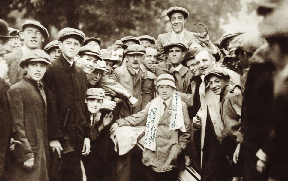 After winning the 1913 U.S. Open, Brookline's Francis Ouimet, rear, credited his caddie, 10-year-old Eddie Lowery. Ouimet later dedicated this photo, writing over Lowery's towel, "This is the boy who won the 1913 Open."