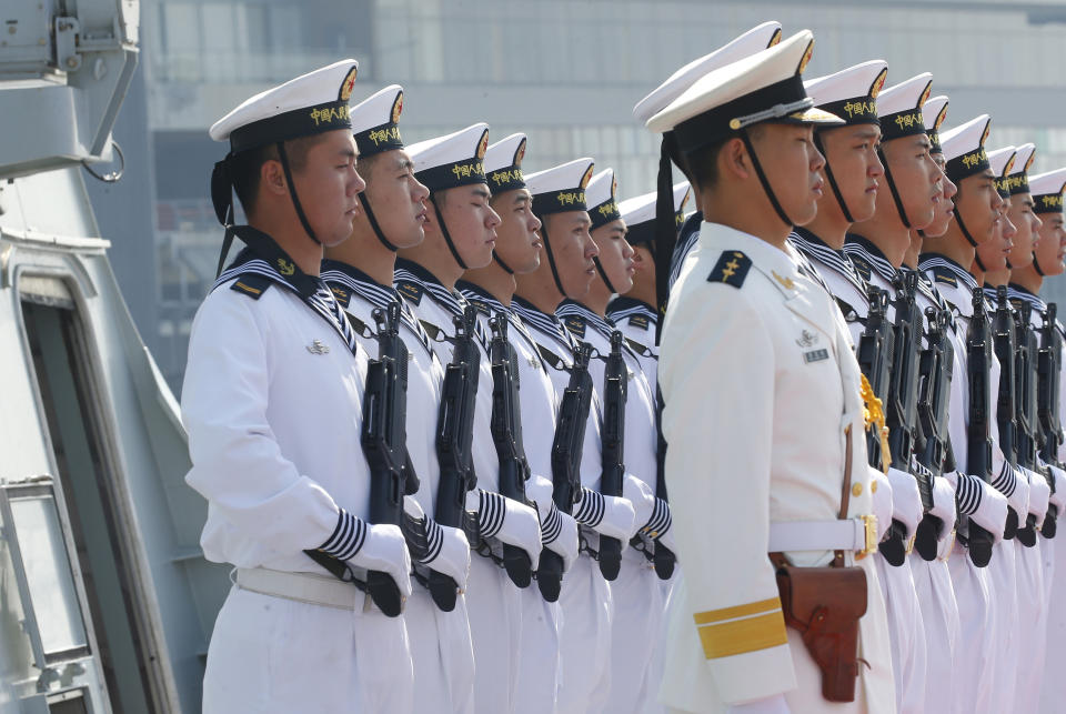 FILE - In this Jan. 17, 2019, file photo, Chinese People's Liberation Navy sailors stand in formation on the deck of a type 054A guided missile frigate "Wuhu" as it docks at Manila's South Harbor for a four-day port call in Manila, Philippines. U.S.-China friction has flared again, with Beijing firing back at accusations by Washington that it is a leading cause of global environmental damage and has reneged on its promise not to militarize the South China Sea. (AP Photo/Bullit Marquez)