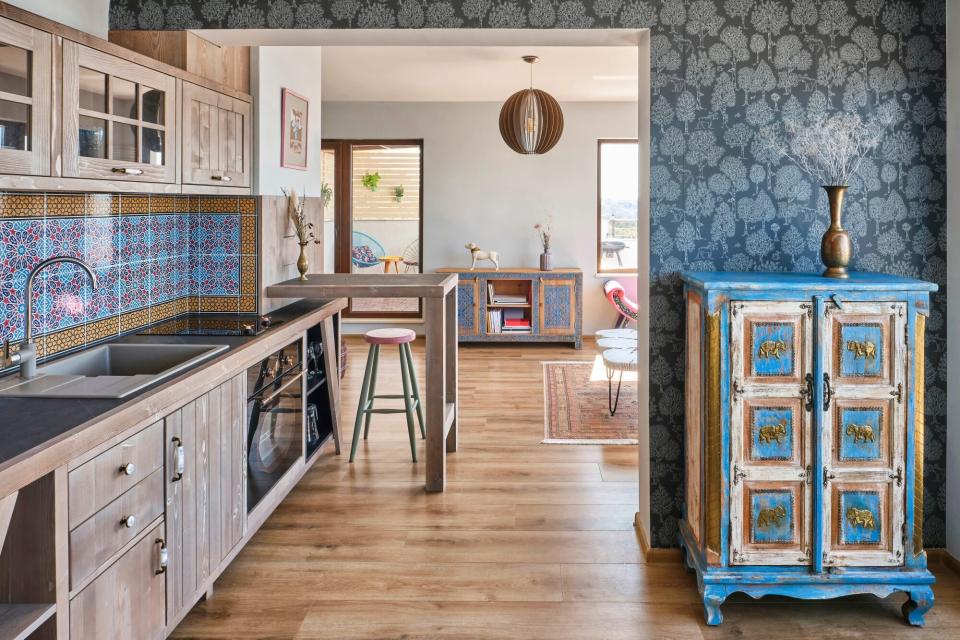 Antique interior design with floral patterns and painted blue cabinet