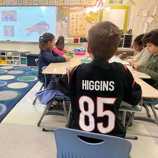 PHOTO: A Kilgour Elementary School student wears a Bengals team jersey in class while writing a get-well note for Bills player Damar Hamlin. (Cincinnati Public Schools)