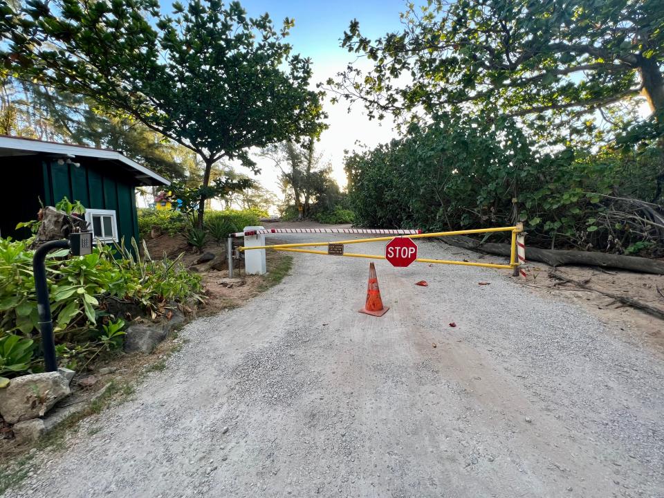 a closed off road with a stop side and a cone