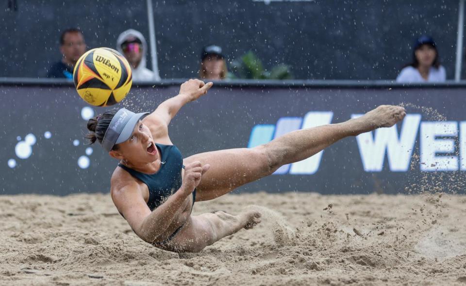 Betsi Flint dives for the ball during the women's championship match at the AVP Manhattan Beach Open.