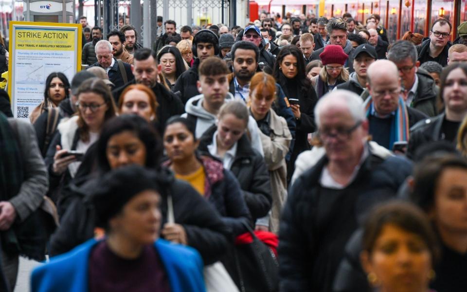 Commuters walk along a platform, during a rail workers strike, at London Waterloo railway station in London, UK, on Thursday, March 16, 2023. Services into the capital will be restricted as workers across 18 companies represented by the RMT union walk out over pay dispute.Â Photographer: Chris J. Ratcliffe/Bloomberg - Chris J. Ratcliffe/Bloomberg