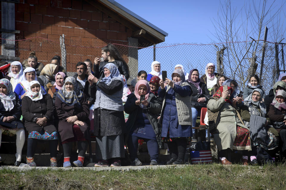 Bulgarian muslims use their mobile phones to make photos during mass circumcision ceremony in the village of Ribnovo, Bulgaria, Sunday, April 11, 2021. Despite the dangers associated with COVID-19 and government calls to avoid large gatherings, Hundreds of people flocked to the tiny village of Ribnovo in southwestern Bulgaria for a four-day festival of feasting, music and the ritual of circumcision which is considered by Muslims a religious duty and essential part of a man's identity. (AP Photo/Jordan Simeonov)