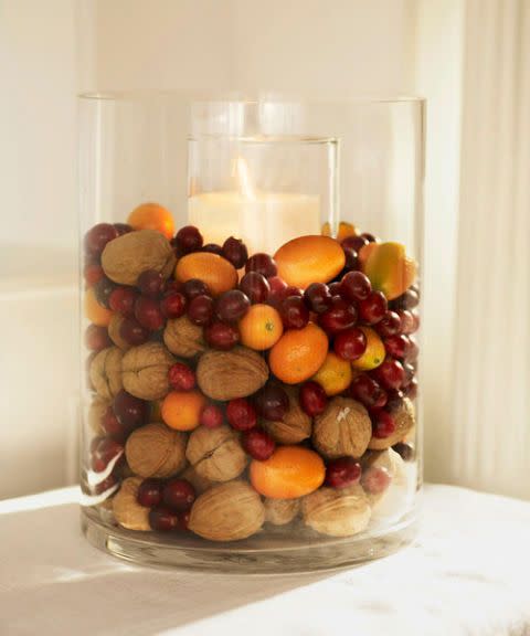 <p>Display winter's most festive foods in a glass vase with a candle in the middle. This one has walnuts, cranberries, and kumquats.</p><p>See more at <a href="http://www.goodhousekeeping.com/holidays/christmas-ideas/how-to/g2203/christmas-decoration-ideas/?slide=19" rel="nofollow noopener" target="_blank" data-ylk="slk:Good Housekeeping;elm:context_link;itc:0;sec:content-canvas" class="link ">Good Housekeeping</a>. </p>