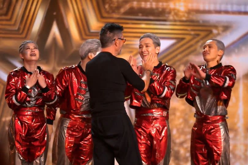 Man congratulating dance group