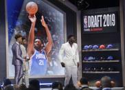 Duke's Zion Williamson, right, leaves the stage after a group photo with other prospects before the NBA basketball draft Thursday, June 20, 2019, in New York. (AP Photo/Frank Franklin II)