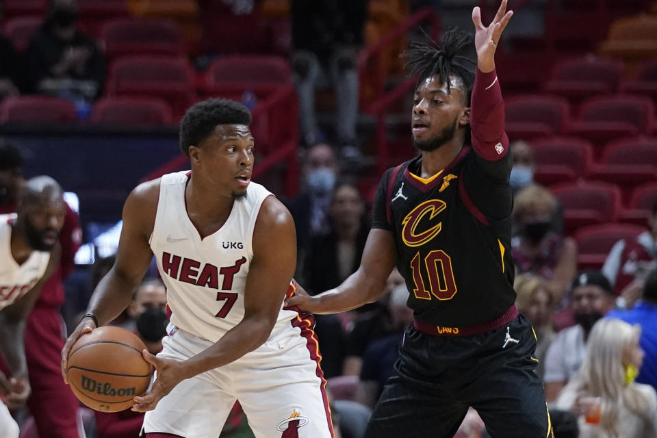 Miami Heat guard Kyle Lowry (7) looks for an open teammate past Cleveland Cavaliers guard Darius Garland (10) during the first half of an NBA basketball game, Wednesday, Dec. 1, 2021, in Miami. (AP Photo/Wilfredo Lee)