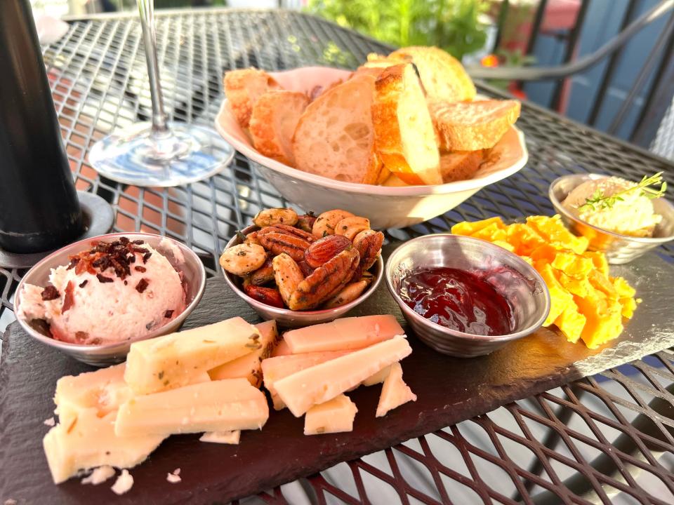 Charles E. Fromage's cheese board includes two house cheeses, fruit jam, herbed mixed nuts, goat cheese and fig spread and a whipped cheese mixture called 5 Cheese Glop.