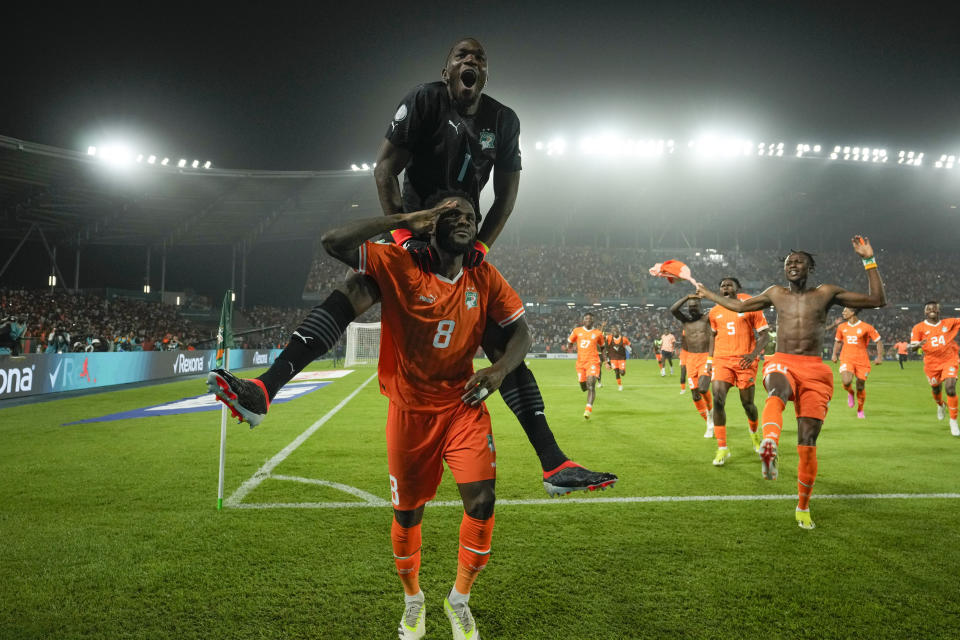 Ivory Coast's Franck Kessie, bottom, celebrates celebrate after defeating Senegal in a penalty shootout during their African Cup of Nations round of 16 soccer match between Senegal and Ivory Coast, at the Charles Konan Banny stadium in Yamoussoukro, Ivory Coast, Saturday, Jan. 20, 2024. (AP Photo/Themba Hadebe)