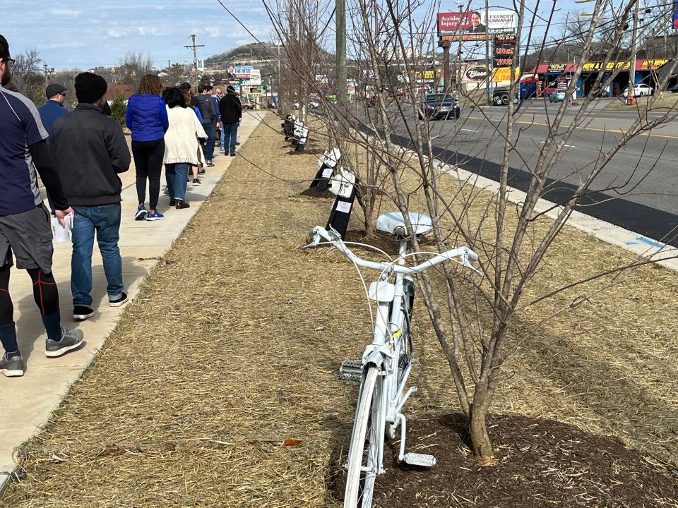 Walkers pay tribute to memorials set up along Dickerson Pike on Saturday, Jan. 28, 2022 for pedestrians and cyclists killed in 2022 because of traffic-related wrecks.