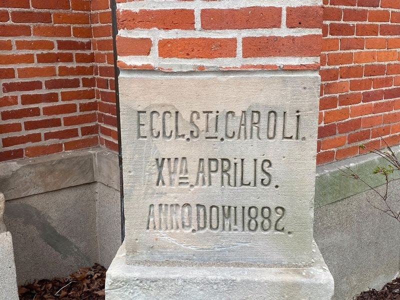 The cornerstone of St. Charles Borromeo Catholic Church reads, in Latin, “April 15 in the year of our Lord 1882.”