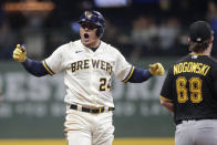 Milwaukee Brewers' Avisail Garcia (24) yells to the dugout after hitting an RBI-double during the seventh inning of a baseball game against the Pittsburgh Pirates, Tuesday, Aug. 3, 2021, in Milwaukee. (AP Photo/Aaron Gash)