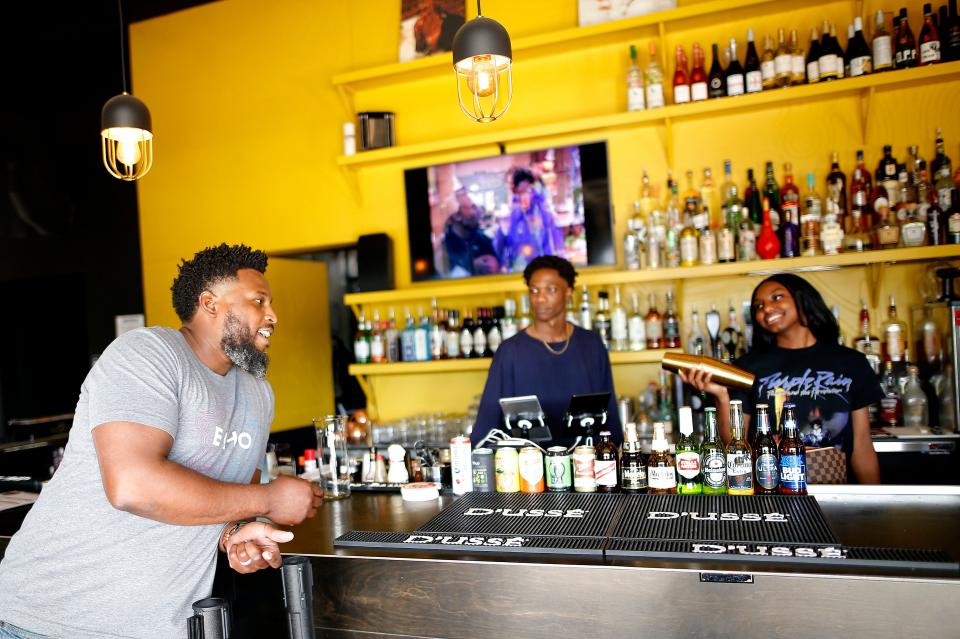 Quintin Hughes Sr. talks with Archiebald Browne and Madyson Saulsberry on April 20, 2022, at Kindred Spirits in Oklahoma City.