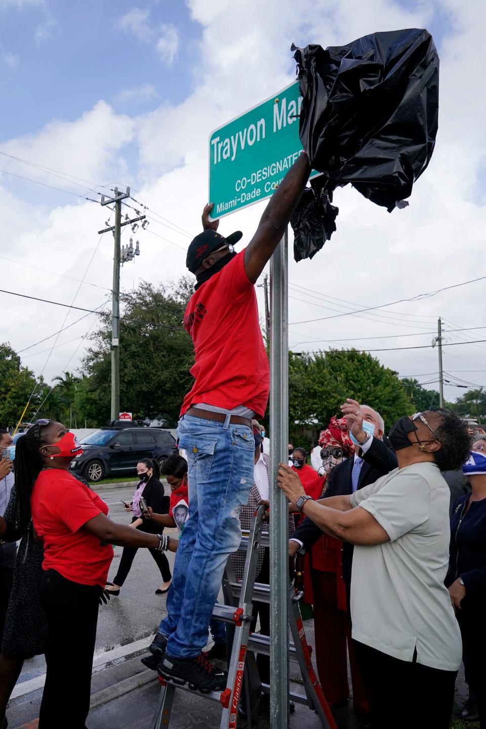 Tracy Martin, father of Trayvon Martin, unveils a sign renaming a street in honor of his son Nov. 5, 2020, in Miami Gardens.