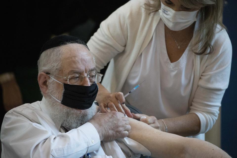 Rabbi Yisrael Meir Lau receives a COVID-19 coronavirus vaccine at the Ichilov Hospital in Tel Aviv, Israel, Sunday, Dec. 20, 2020. (AP Photo/Ariel Schalit)