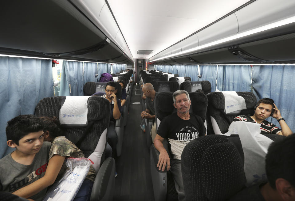 In this July 18, 2019 photo, migrants sit in a bus that will take them and other migrants to Moneterrey, from an immigration center in Nuevo Laredo, Mexico. In Monterrey they found a city where shelters are already overflowing and it quickly became clear that it would be up to them to make do as best as they could. (AP Photo/Marco Ugarte)