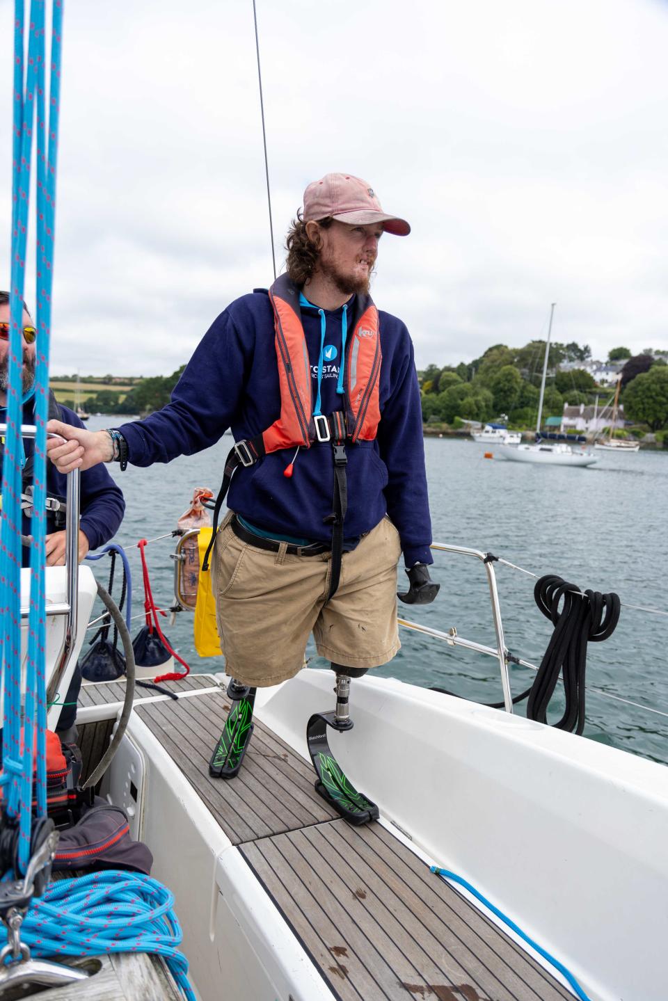 Craig Wood standing on his sailing boat wearing a life jacket