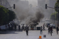 Palestinian demonstrators clash with the Israeli army while forces carry out an operation in the West Bank town of Nablus, Tuesday, Aug. 9, 2022. Israeli police said forces encircled the home of Ibrahim al-Nabulsi, who they say was wanted for a string of shootings in the West Bank earlier this year. They said al-Nabulsi and another Palestinian militant were killed in a shootout at the scene, and that troops found arms and explosives in his home. (AP Photo/Majdi Mohammed)