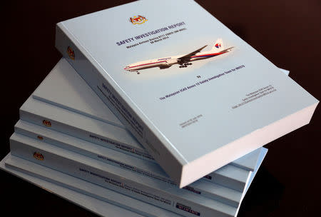FILE PHOTO: A stack of MH370 safety investigation report booklets are pictured at a closed door meeting with family members in Putrajaya, Malaysia July 30, 2018. REUTERS/Sadiq Asyraf/File Photo
