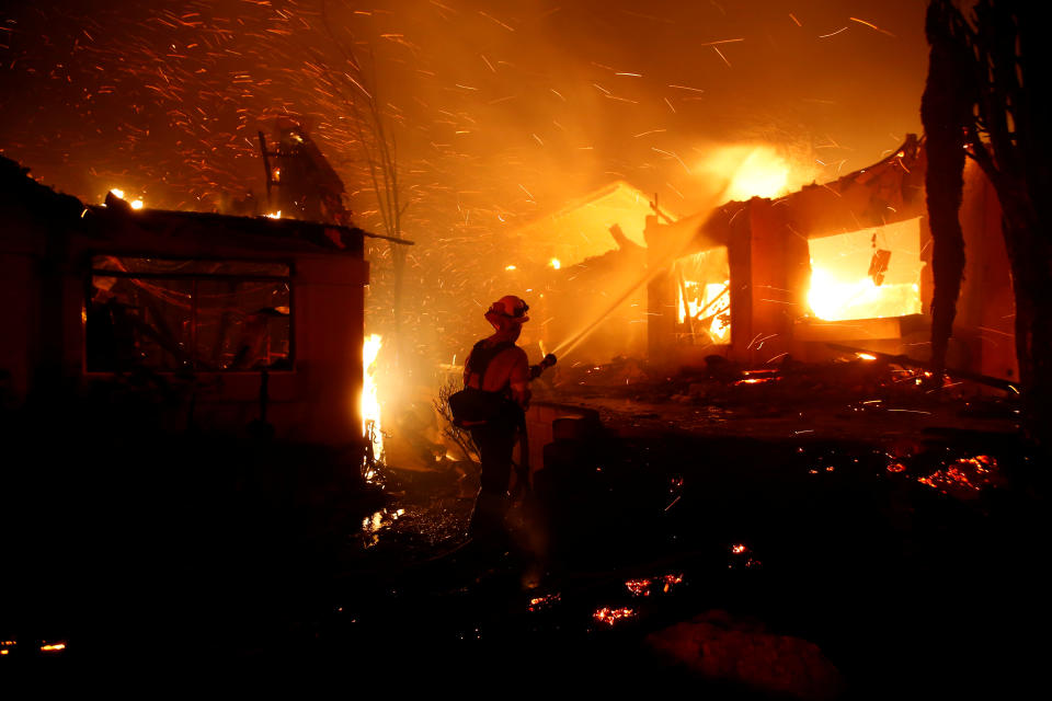 Firefighters battle flames overnight during a wildfire that burned dozens of homes in Thousand Oaks. Image: AP