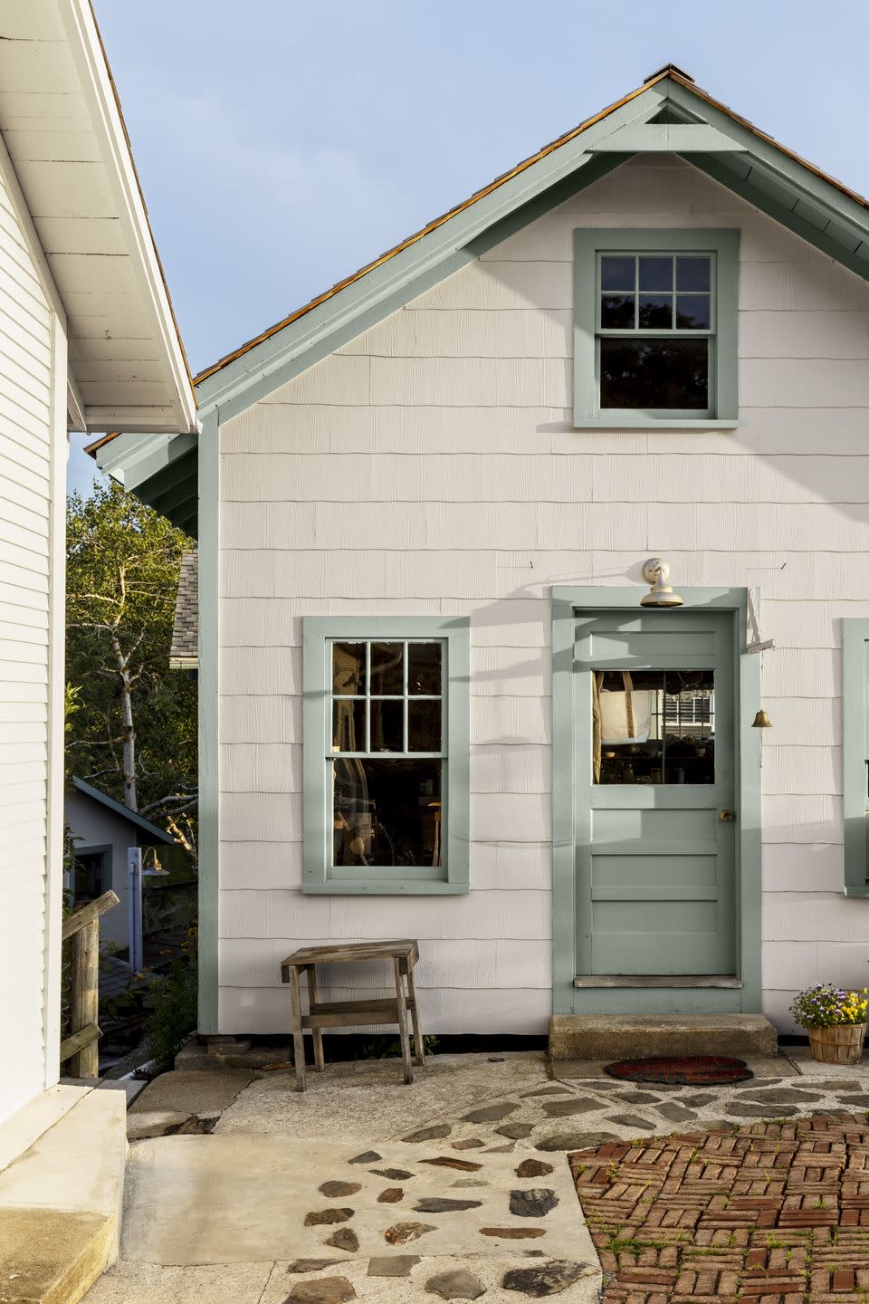 a white house with green door