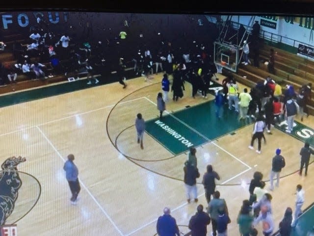 This screen shot of the IHSAA live feed from Thursday, Feb. 2, 2023, shows a fight breaking out in the stands of the South Bend Washington-South Bend Riley high school boys basketball game. The game was postponed at halftime as a result