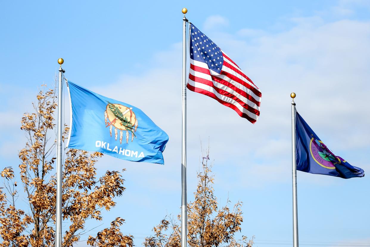 The Oklahoma, U.S. and Chickasaw Nation flags fly outside a Chickasaw Nation visitor center in Davis.